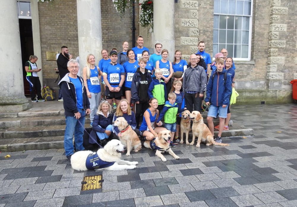 a group of people posing for a photo with dogs