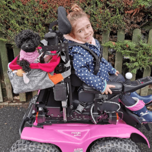 Tinker a girl sitting on a pink electric vehicle